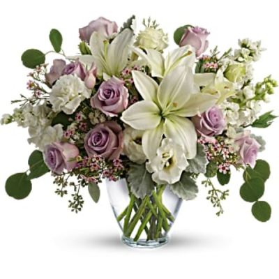 <div id="mark-2" class="m-pdp-tabs-marketing-description">Luxe in love! Pale lavender roses, creamy white lilies and delicate greens create a soft sweet bouquet that's as tender as your feelings.</div>
<div id="desc-2">
<ul>
 	<li>Lavender roses, white asiatic lilies, white lisianthus, white stock, lavender waxflower, and white sinuata statice are accented with dusty miller, seeded eucalyptus, and silver dollar eucalyptus.</li>
 	<li>Delivered in a serenity vase.</li>
</ul>
</div>