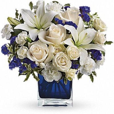 <div class="m-pdp-tabs-description">
<div id="mark-1" class="m-pdp-tabs-marketing-description">Send someone a bit of heaven with this beautiful bouquet. Luxurious crème roses and pure white lilies paint a peaceful picture inside a blue cube.</div>
</div>
<p id="arrngDescp">Crème roses, white asiatic lilies and white miniature carnations are mixed with bursts of purple statice and green pitta negra. Delivered in a glass cube.</p>