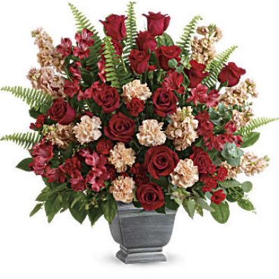 <div class="m-pdp-tabs-description">
<div id="mark-1" class="m-pdp-tabs-marketing-description">A bold expression of your deepest condolences, this elegant mix of red and peach blooms in a large antiqued pot brings strength and comfort.</div>
</div>
<p id="arrngDescp">Red roses, red alstroemeria, peach carnations, miniature red carnations, and peach stock are arranged with spiral eucalyptus, seeded eucalyptus, sword fern, and lemon leaf.</p>